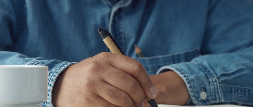 storyblocks-closeup-mans-hands-making-notes-1036x