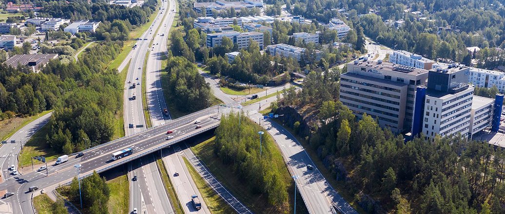 a highway with a bridge and buildings