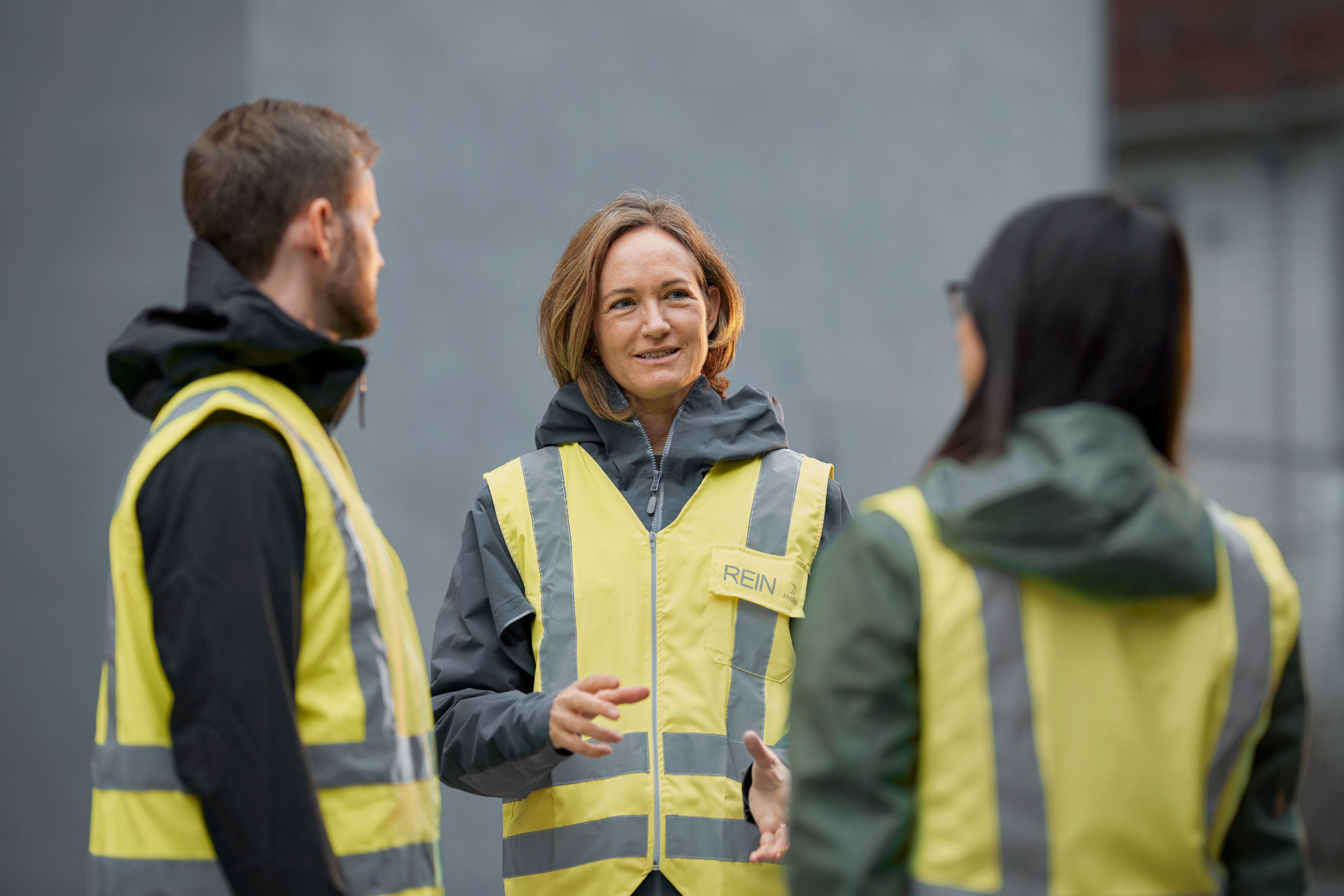a group of people in yellow jackets