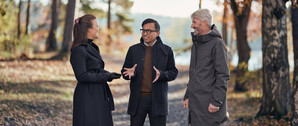 a group of people walking in a forest