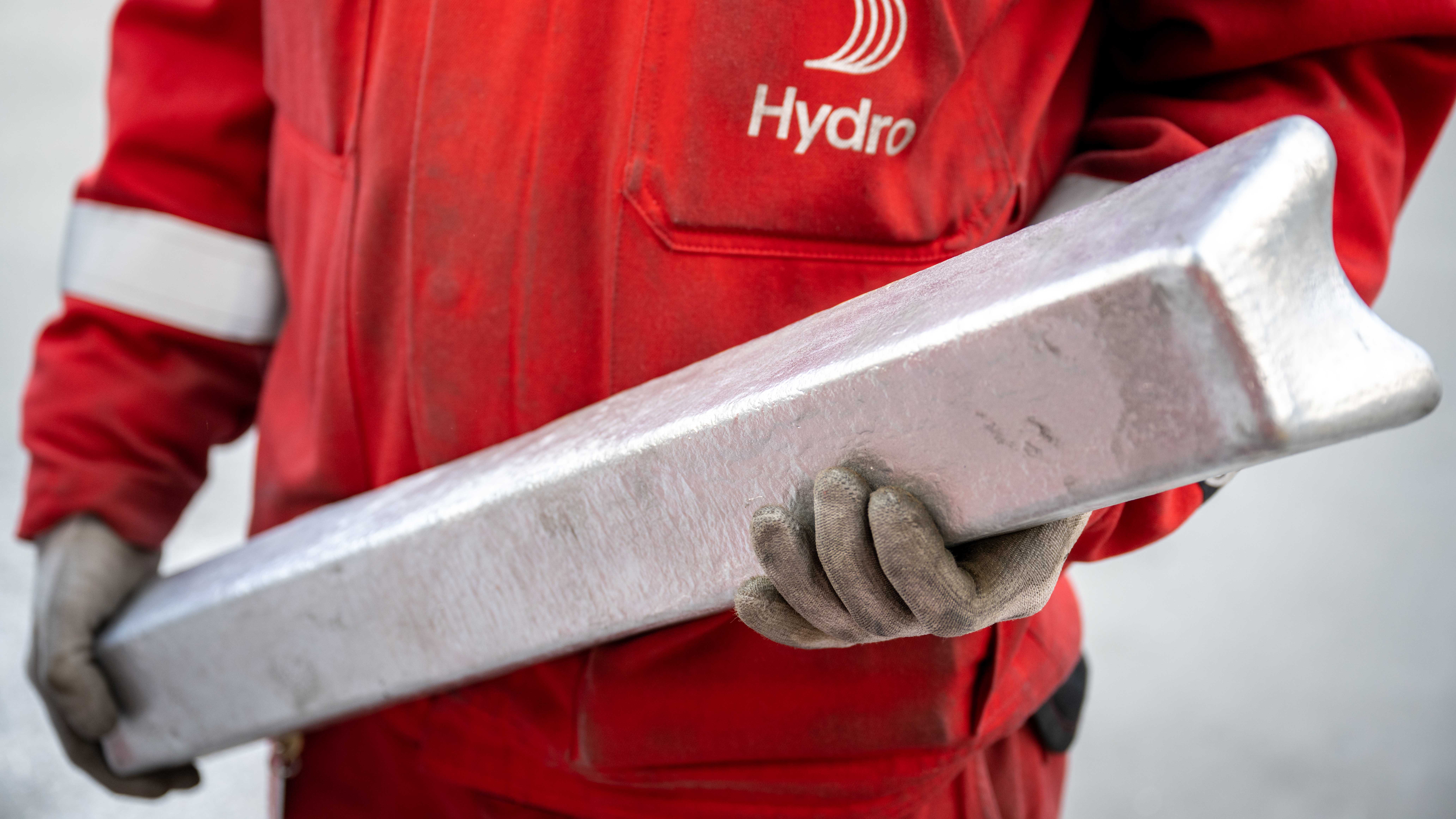 Worker holding aluminium ingot