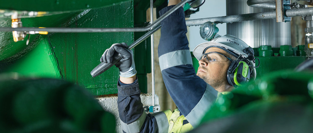 a person wearing a helmet and goggles working on a bar