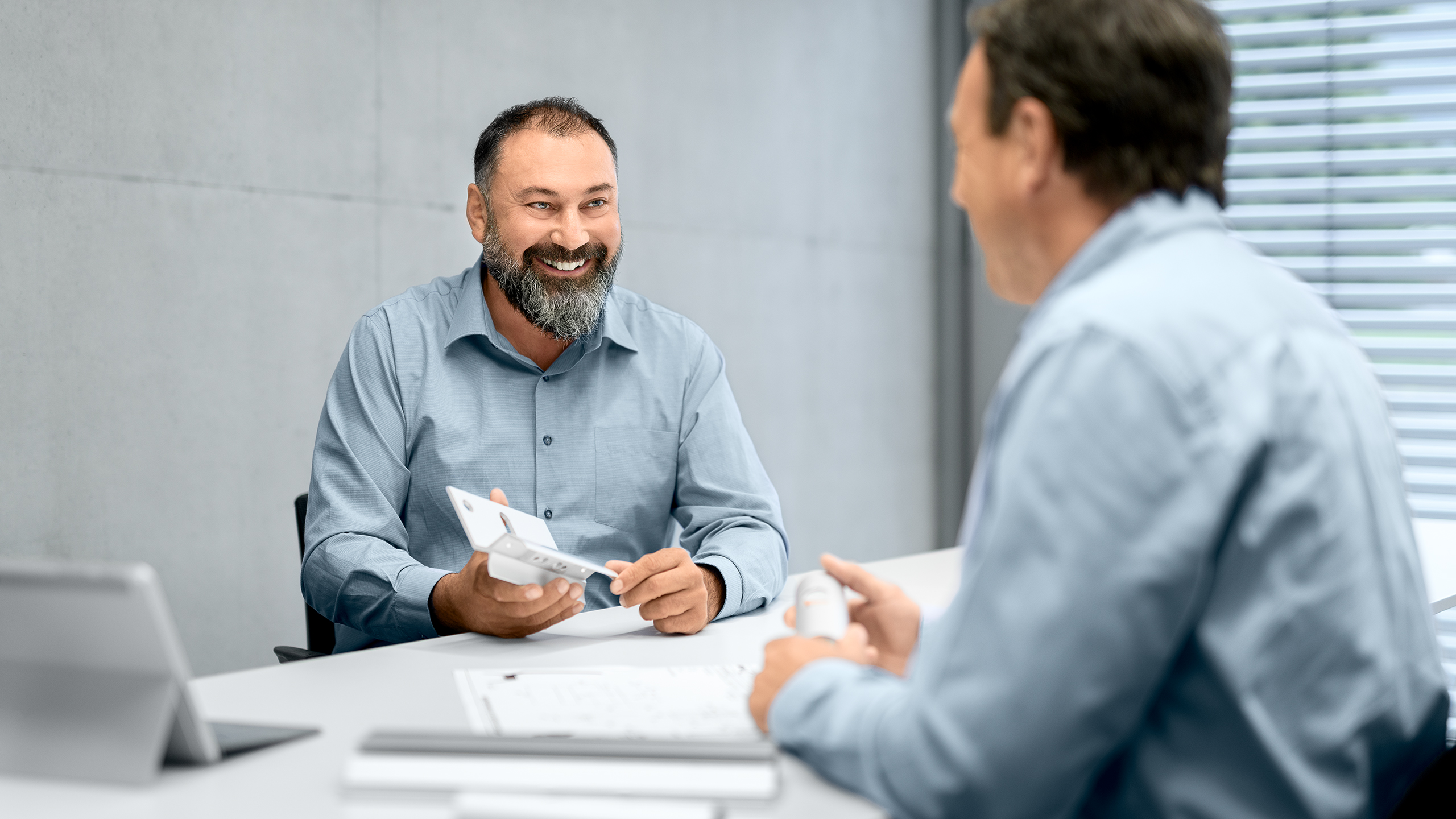 a man showing a man something on the paper