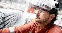 worker with stacks of aluminum bars