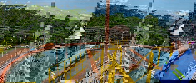 a person wearing a helmet and riding a boat on a river