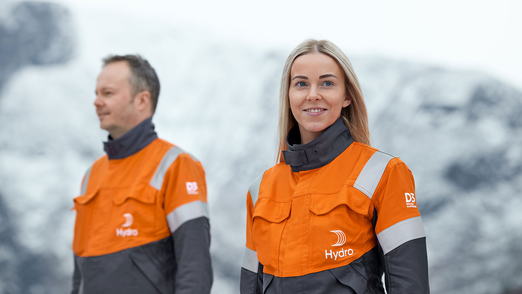 a man and a woman in orange jackets