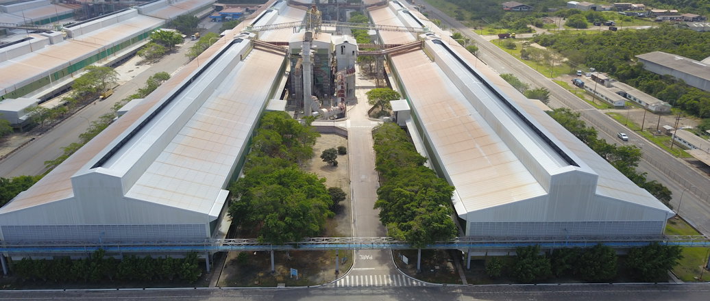 a large building with a road and trees around it