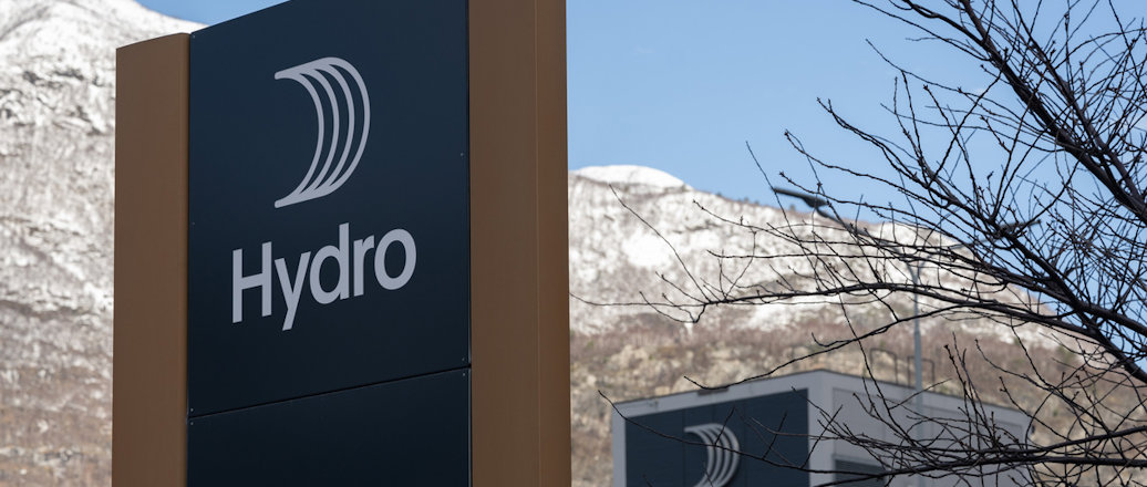 a sign with a building in the background