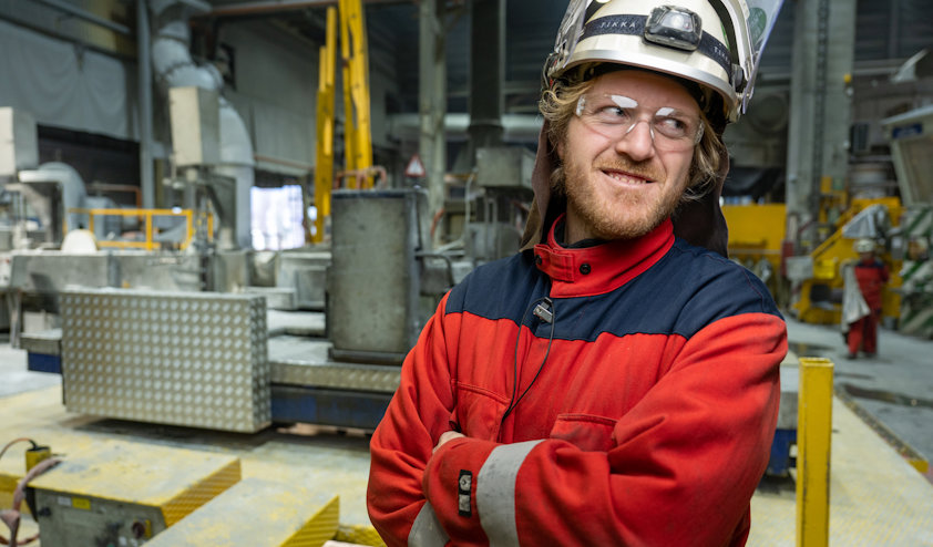 a man wearing a hard hat and protective glasses