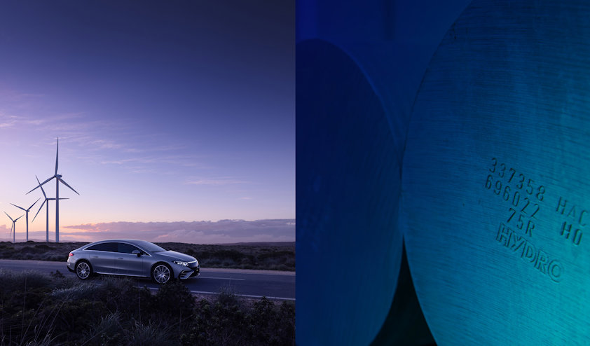 a car against with a windmill in the background