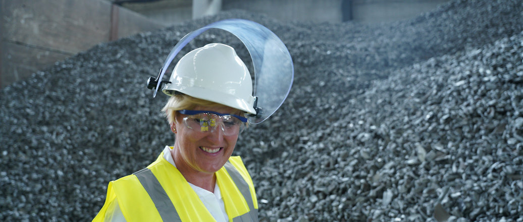 a woman wearing a hard hat and safety goggles