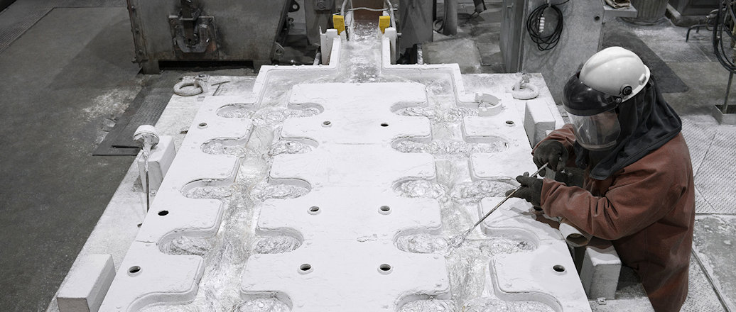 a person in a helmet working on a sculpture