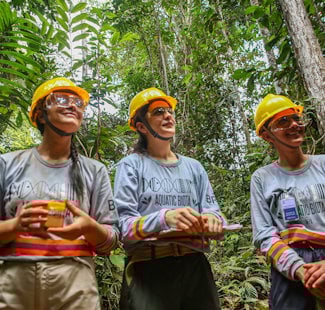 a group of people standing in the woods