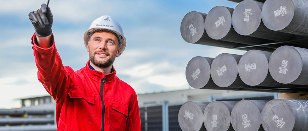 a man standing next to aluminium