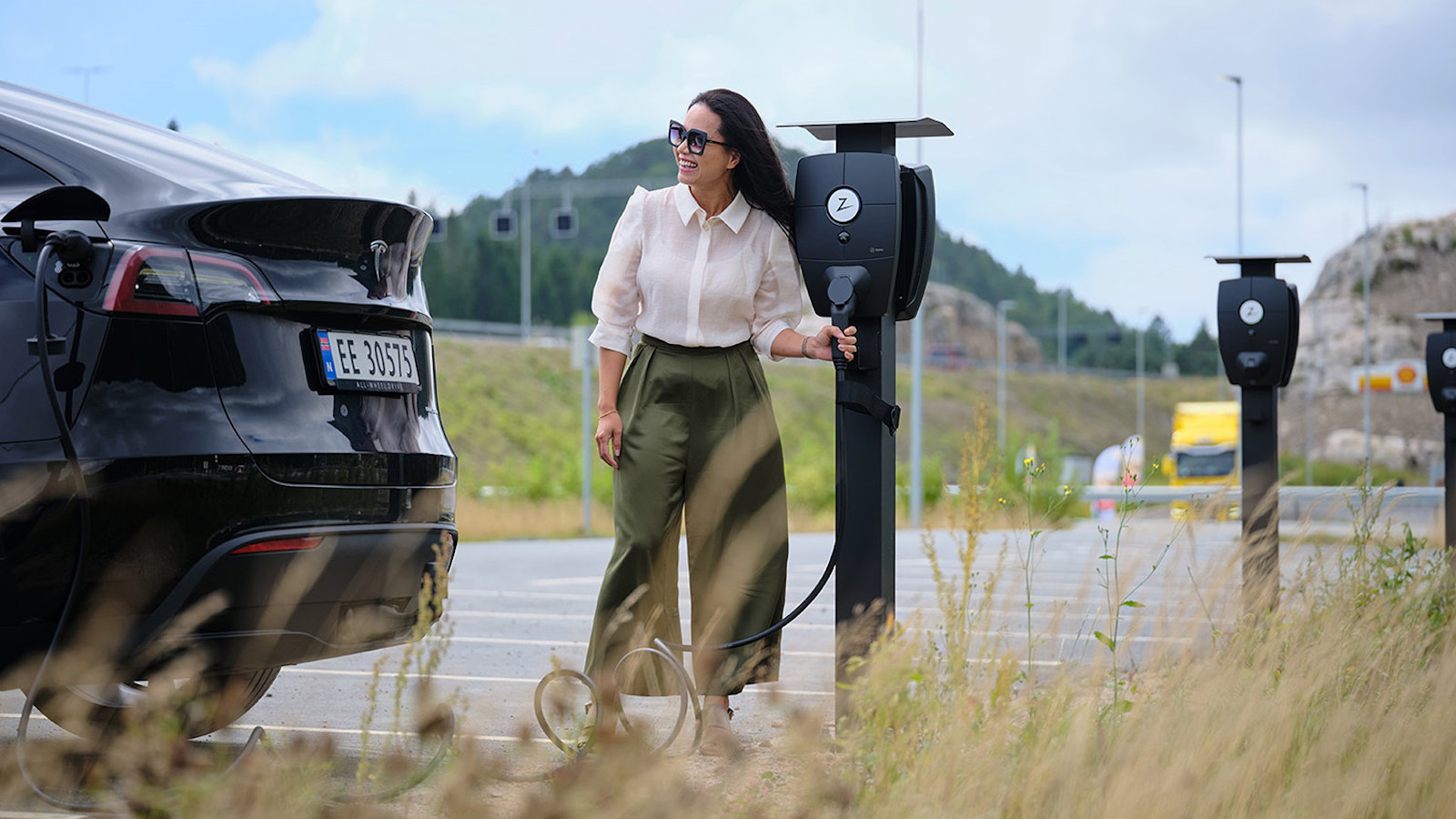 a woman charging an electric car