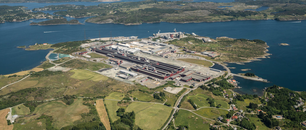 a factory next to a body of water