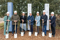 a group of people wearing hardhats and holding shovels
