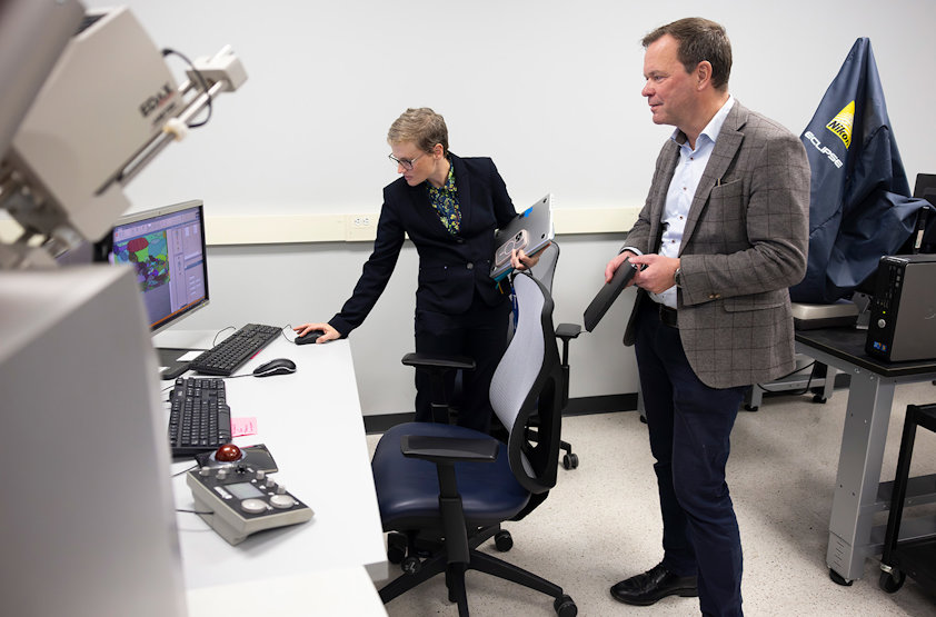 a man and a woman looking at a computer screen