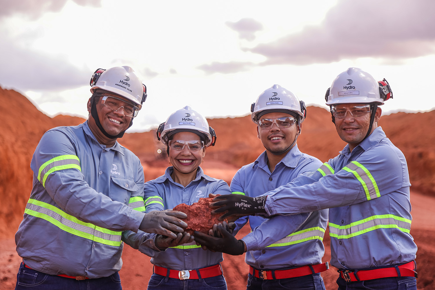 a group of people wearing helmets and holding a baby