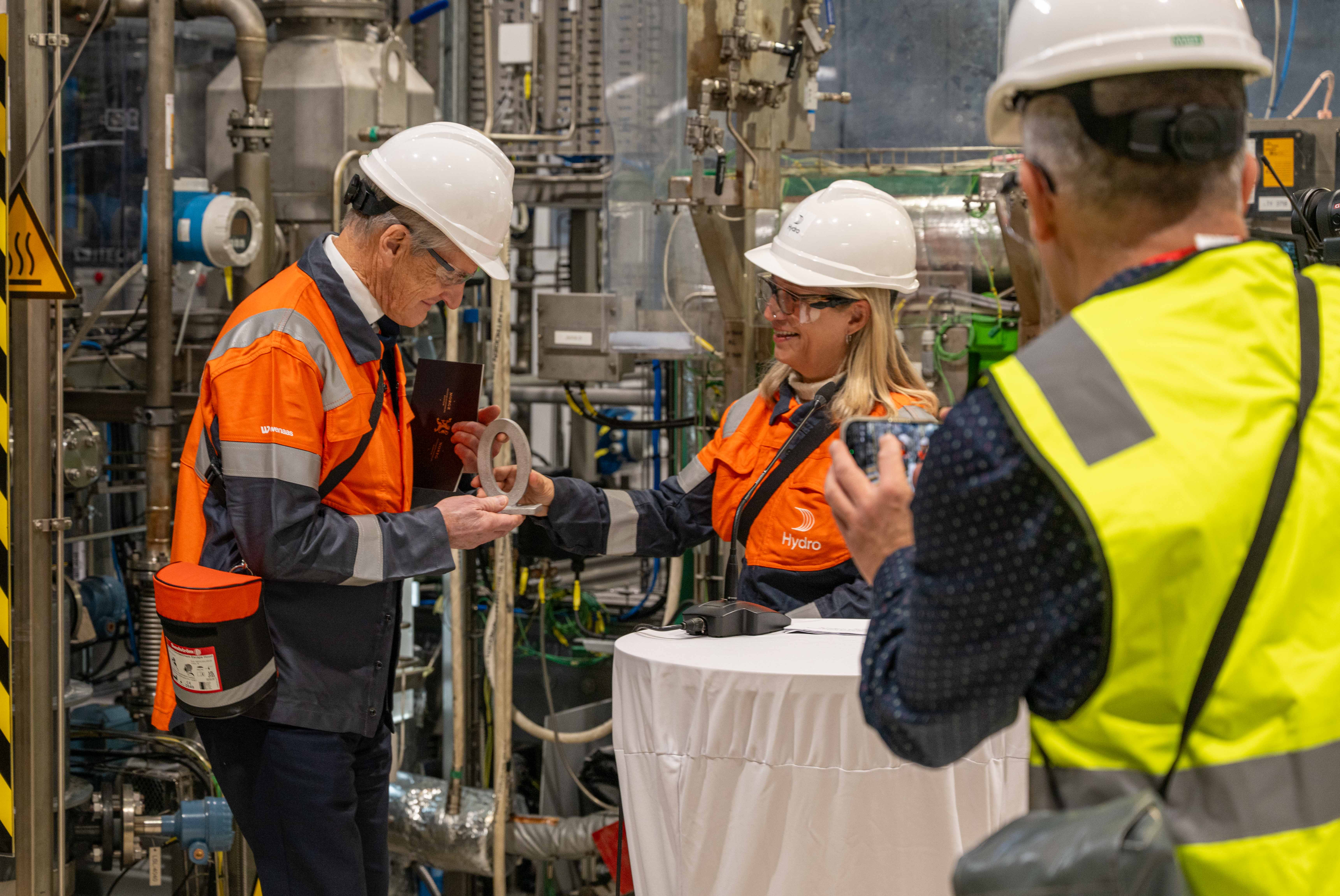 Norway's Prime Minister Jonas Gahr Støre is handed the first metal made from HalZero electrolysis at Herøya