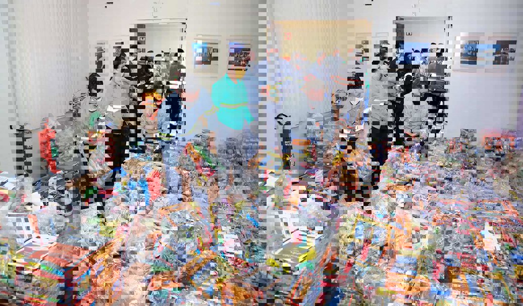 a group of people standing in a room full of boxes