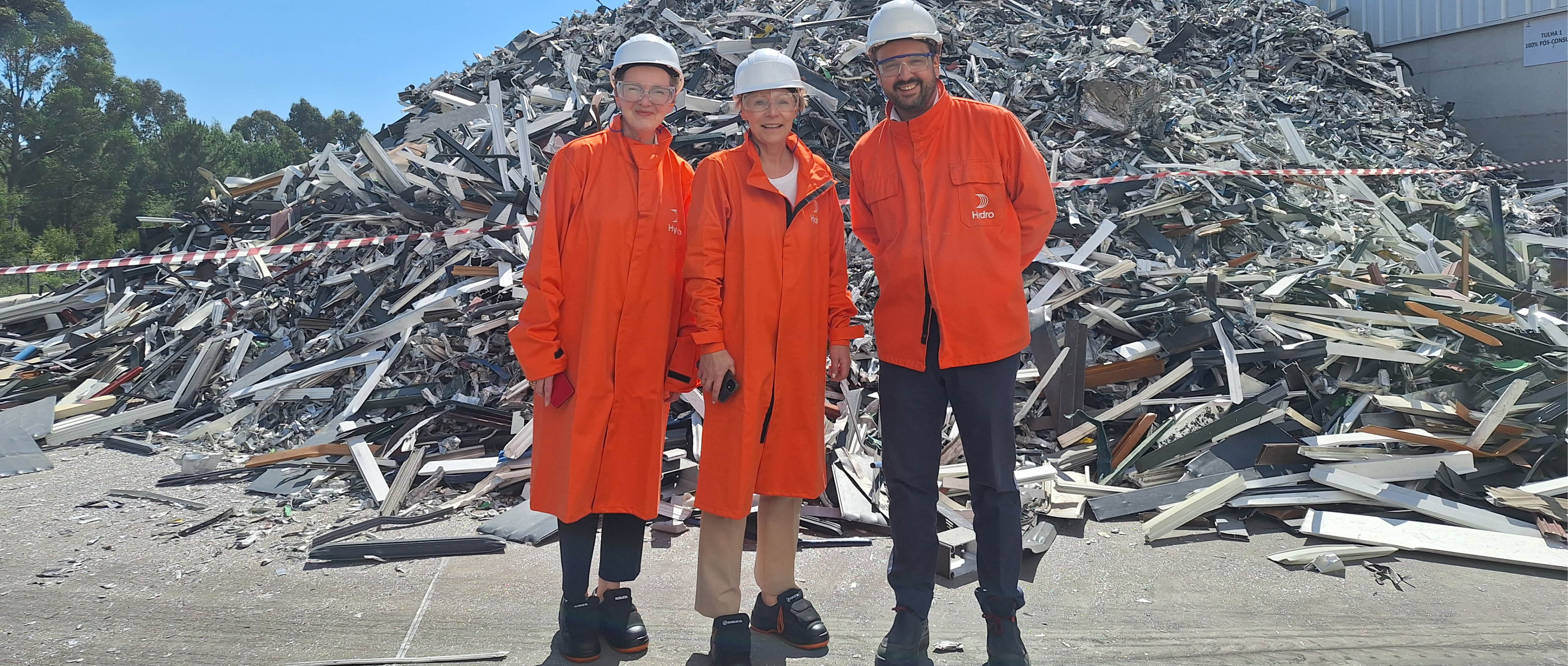a group of men wearing hardhats and standing in front of rubble