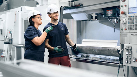 a man and woman wearing hard hats