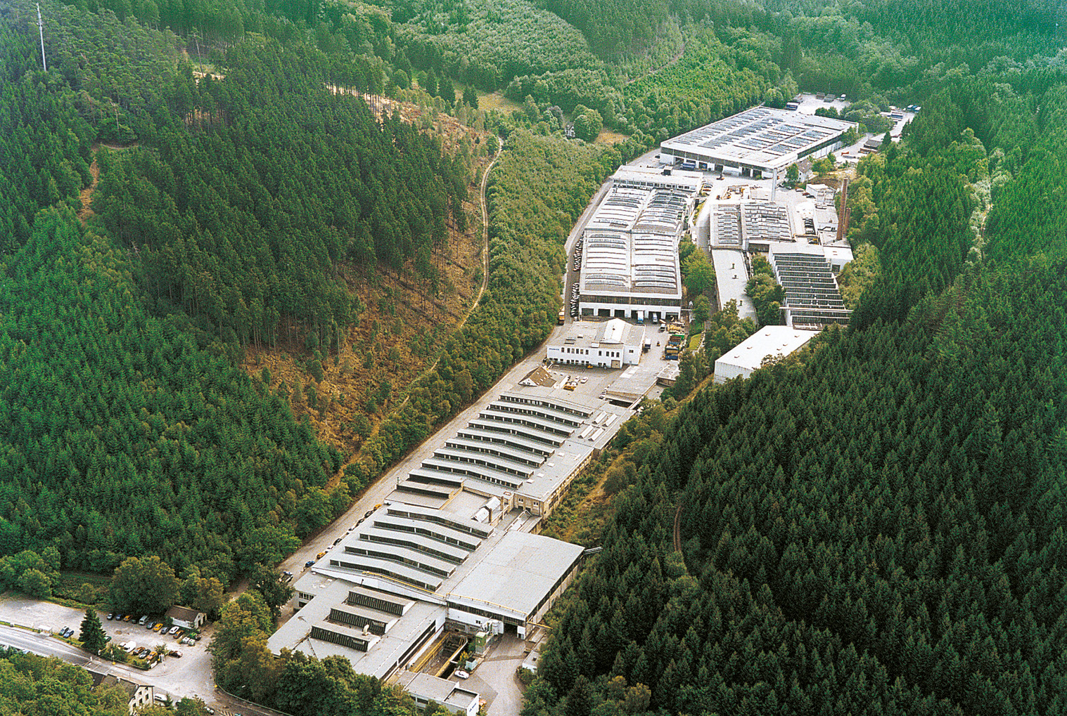 a large building with a large roof surrounded by trees