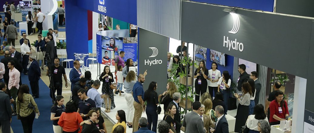 a group of people standing in front of a sign