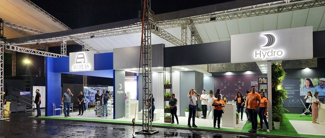 a group of people standing in front of a stage