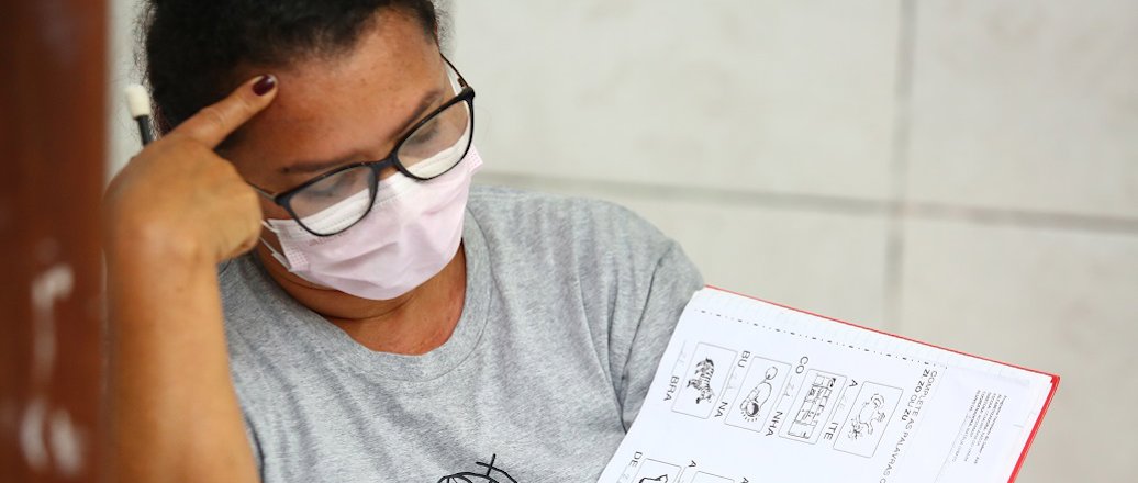 a man holding a pen to his ear