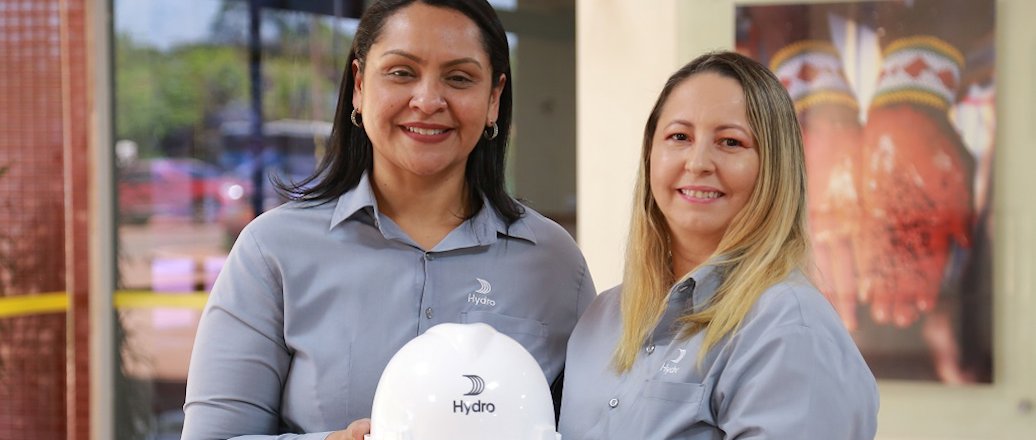 a couple of women holding a white ball