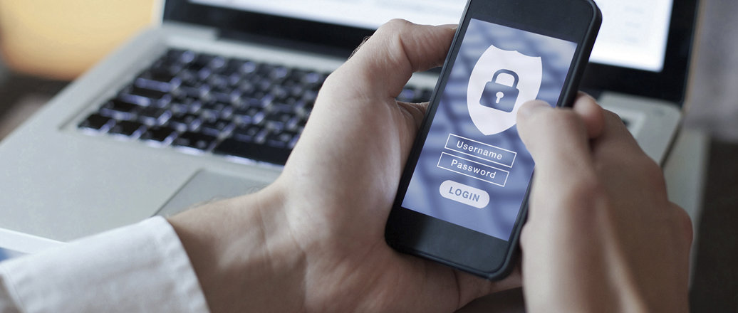 Hands holding smartphone with login screen