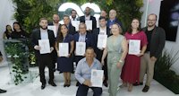 a group of people holding certificates